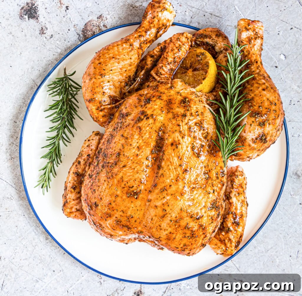 Succulent Instant Pot Rotisserie Chicken 7 Perfectly cooked Instant Pot Rotisserie Chicken on a serving platter with herbs