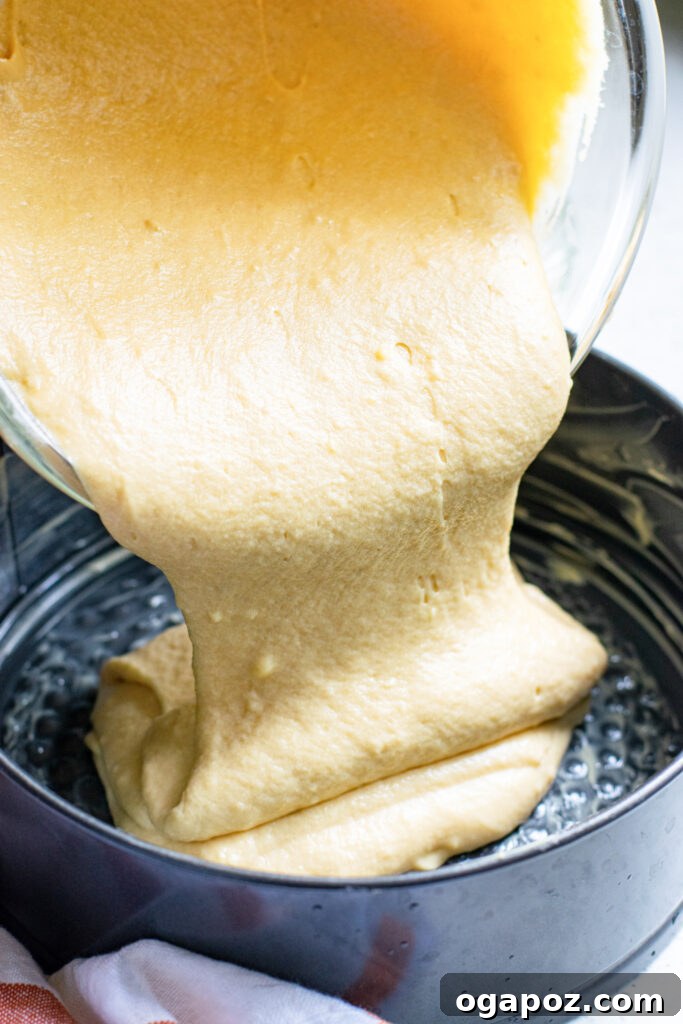 Heavenly Almond Cake 6 Almond Cake batter being poured into a baking pan.