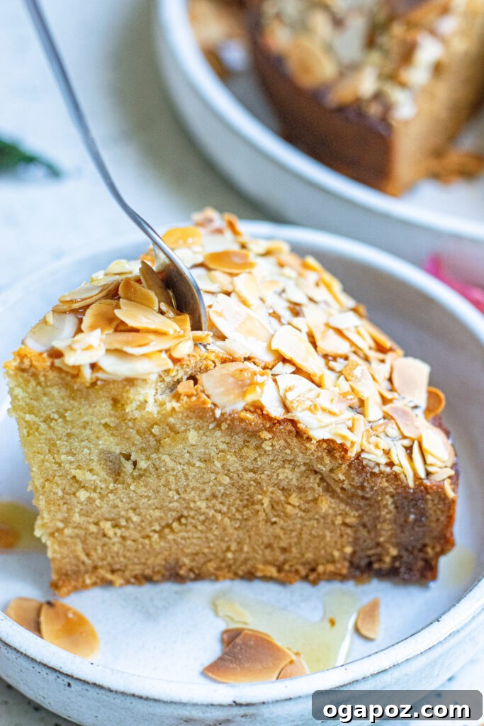 Heavenly Almond Cake 10 A slice of Almond Cake with a fork, ready to be enjoyed.