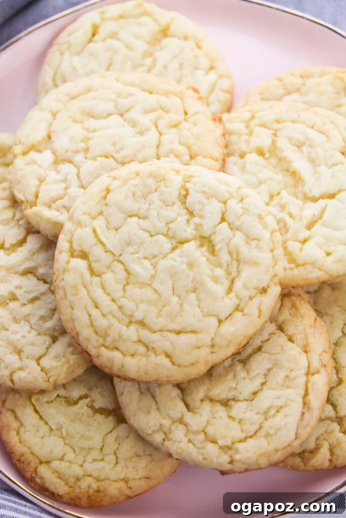 The Easiest Cake Mix Sugar Cookies 4 Easy Cake Mix Sugar Cookies glistening on a pink plate after baking.