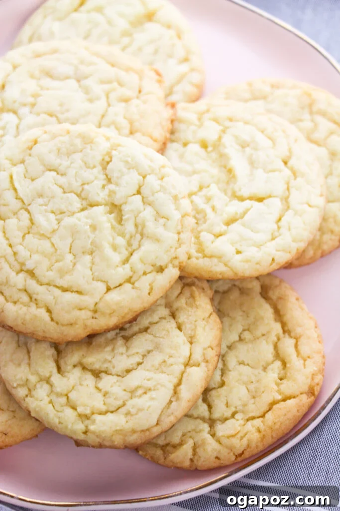 The Easiest Cake Mix Sugar Cookies 8 Beautifully decorated Easy Cake Mix Sugar Cookies arranged on a plate.