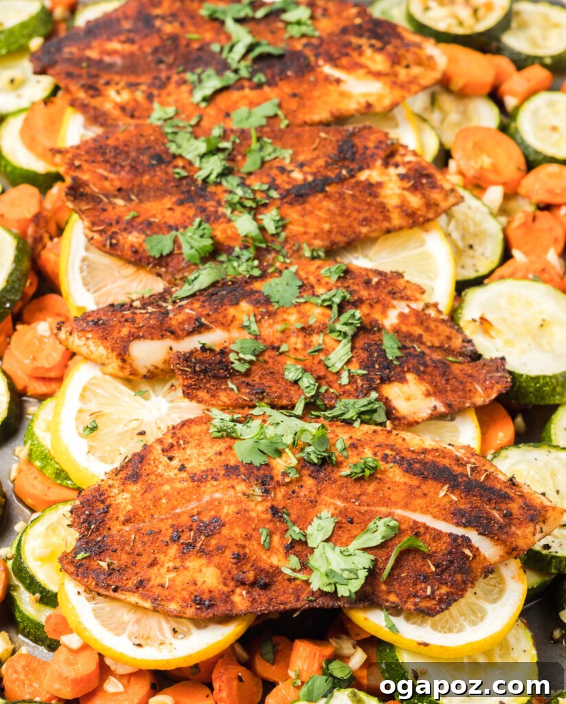 Effortless Blackened Tilapia 2 Easy Blackened Tilapia Fish with roasted vegetables on a baking tray