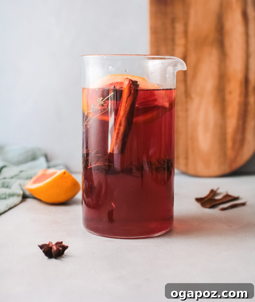 A large pitcher filled with Cranberry Wine Spritzer, ready for serving guests