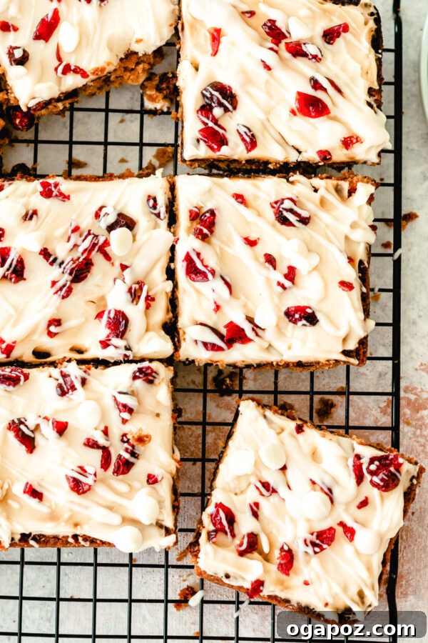 Crimson Cranberry Dream Bars 2 Cranberry Bliss Bars on wire rack, a festive sweet treat with white chocolate and dried cranberries, perfect for holidays