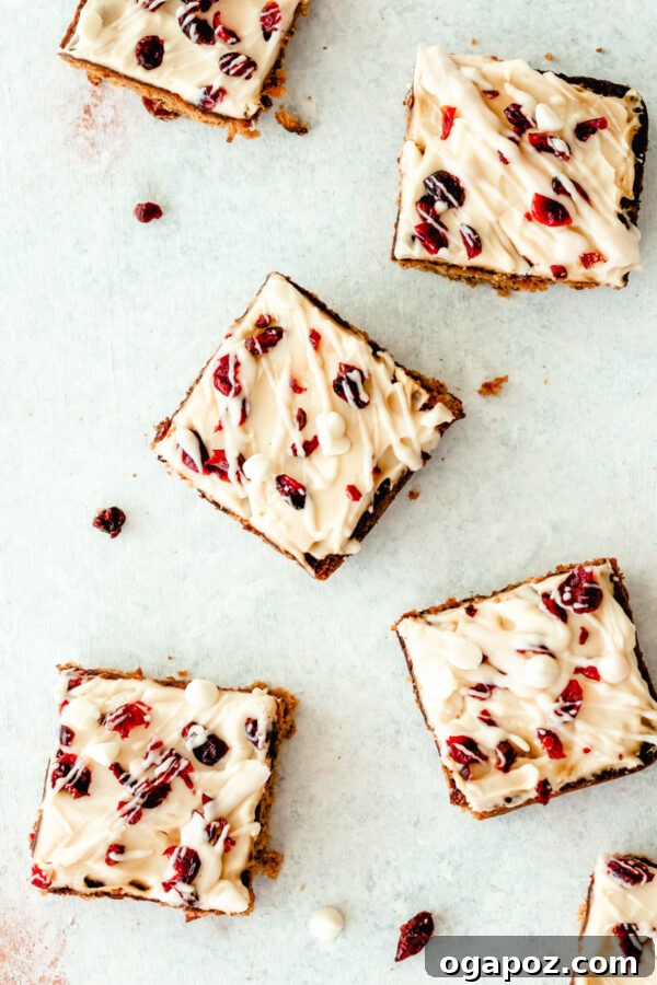 Crimson Cranberry Dream Bars 10 Finished Cranberry Bliss Bars cut into triangles on a white serving board
