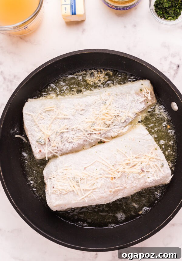 Golden Garlic Butter Seared Cod 7 Flipping pan-fried cod in a skillet, revealing a perfectly golden and crispy underside