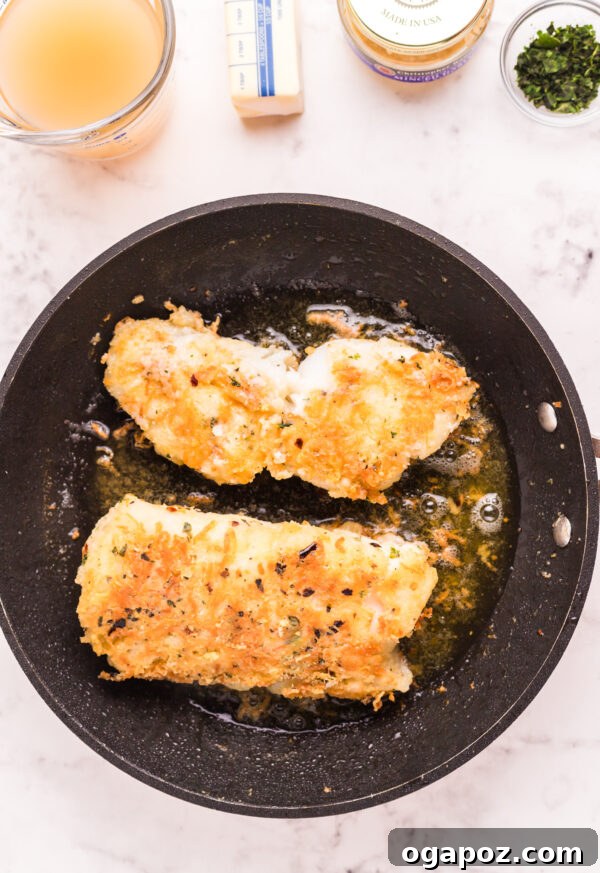 Golden Garlic Butter Seared Cod 8 Cooked pan-fried garlic butter cod fillets resting on a plate, showing the beautifully browned crust