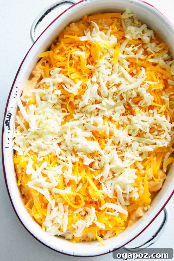 Ultimate Buffalo Chicken Dip Recipe 8 Buffalo Chicken Dip topped with remaining cheese before baking