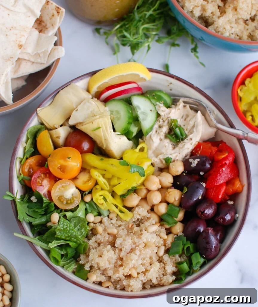 Zesty Greek Quinoa Nourish Bowl 2 Vibrant Greek Quinoa Bowl piled high with fresh vegetables and hummus