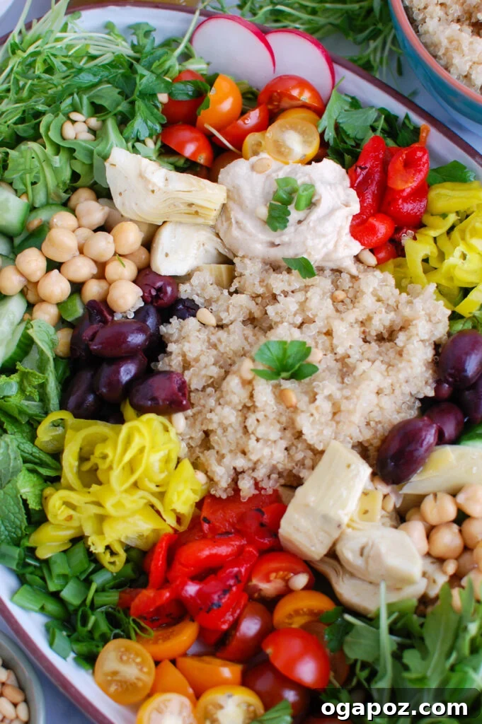 Zesty Greek Quinoa Nourish Bowl 4 Close-up of a Greek Quinoa Bowl showcasing fresh greens and other toppings
