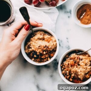 A bowl of slow cooker pumpkin spice steel cut oatmeal, garnished with nuts and a spoon, ready to be enjoyed.