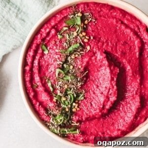 Easy Beet Hummus in a serving bowl with pita bread