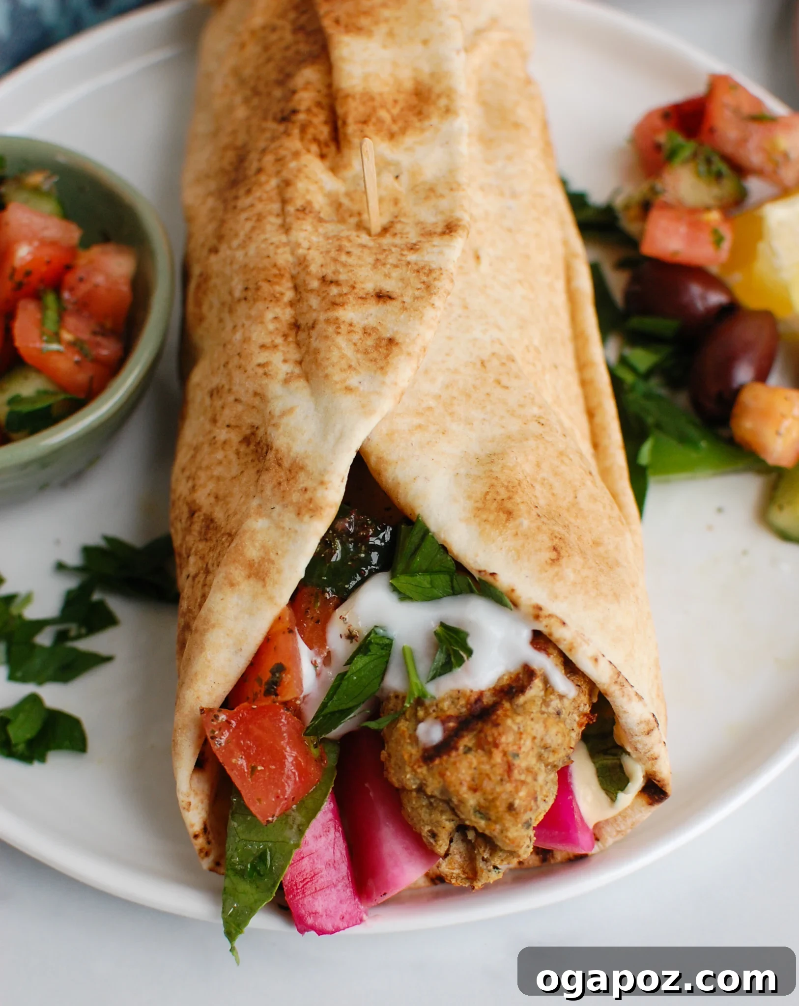 Chicken Kofta wrapped in a fresh pita bread with various toppings.