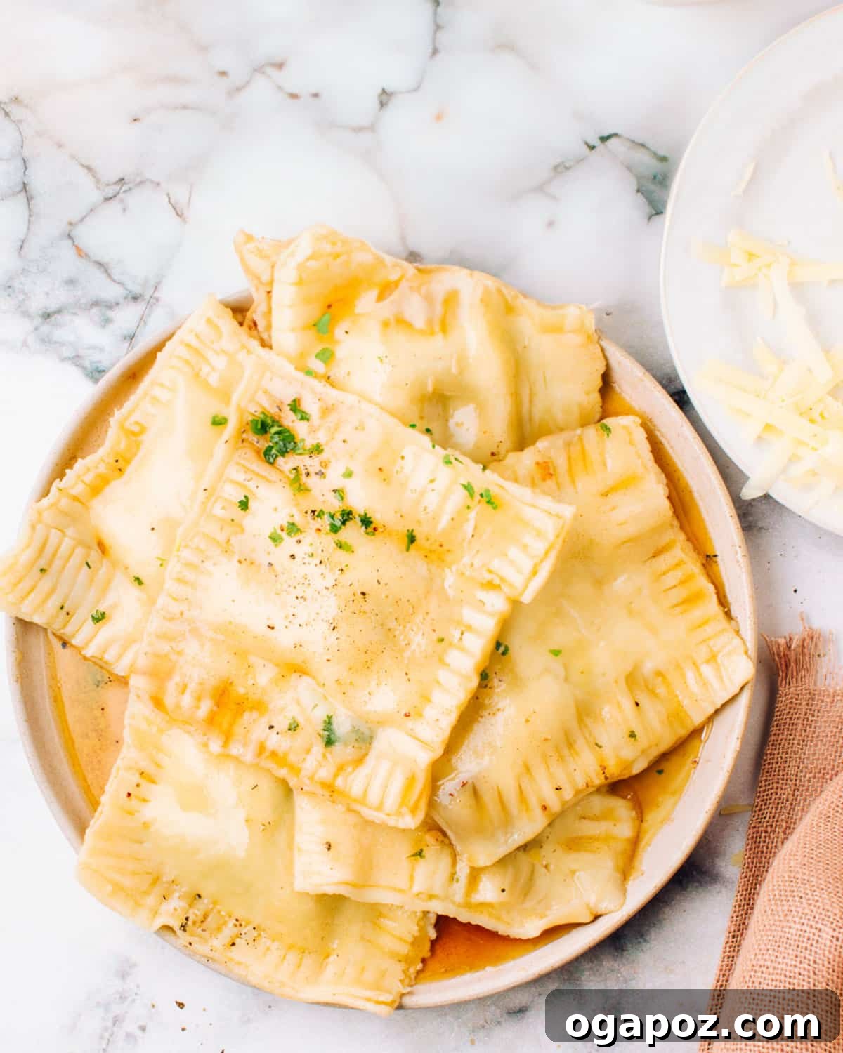 The Easiest 3 Ingredient Garlic Butter Sauce 6 Garlic butter sauce generously poured over ravioli, garnished with fresh herbs.