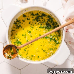 Garlic Butter Sauce with a spoon in a pot.