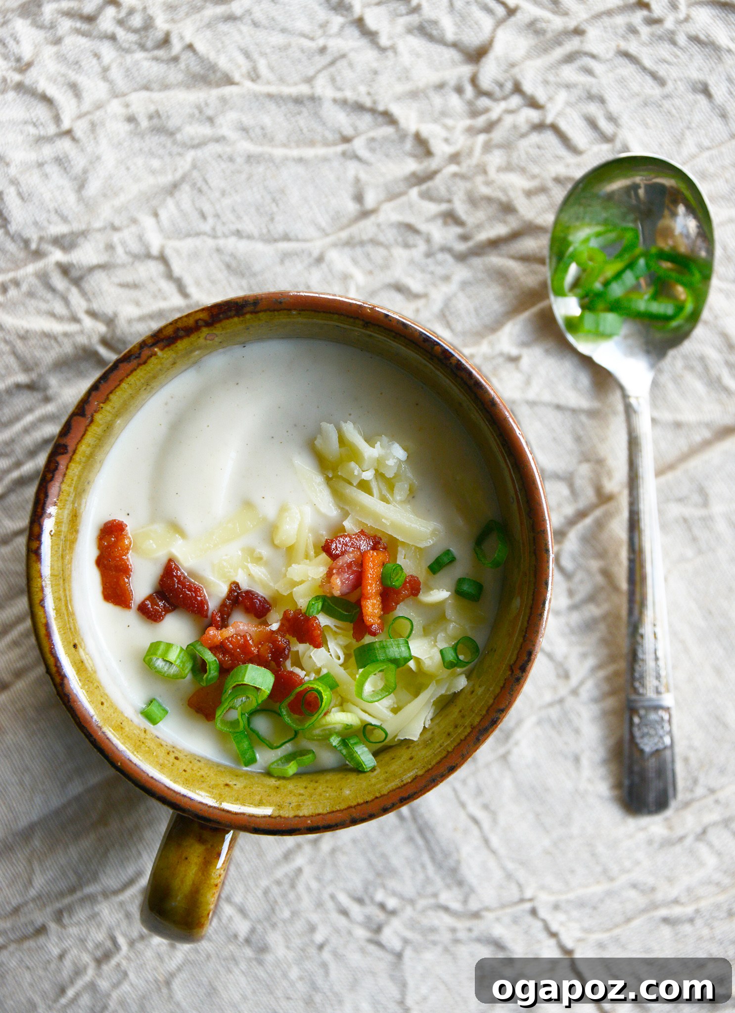 Instant Pot Cauliflower Soup with green onions on the soup.