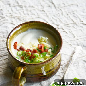 Instant Pot Cauliflower Soup in a bowl with a spoon.