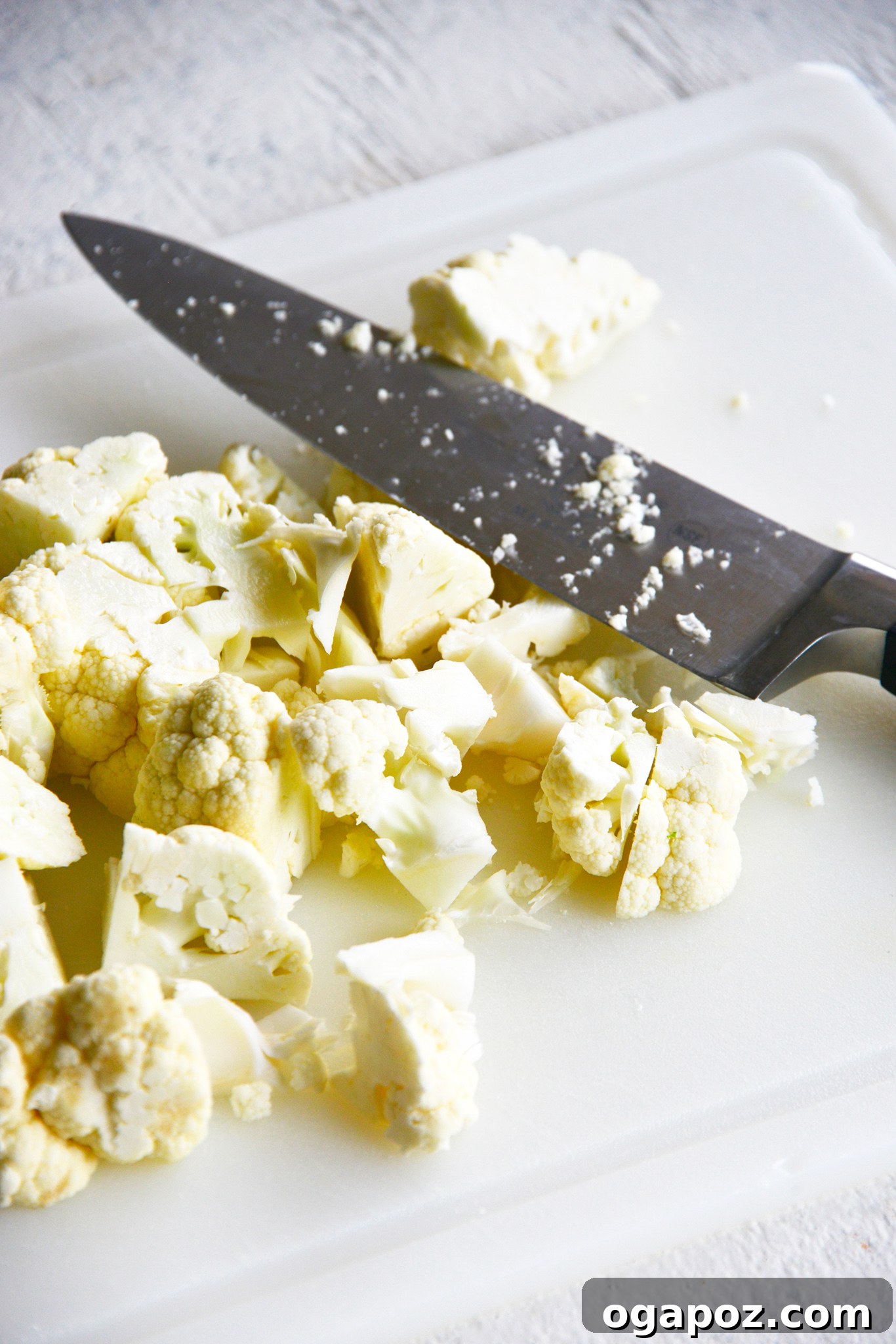 Instant Pot Cauliflower Soup cauliflower with a knife.