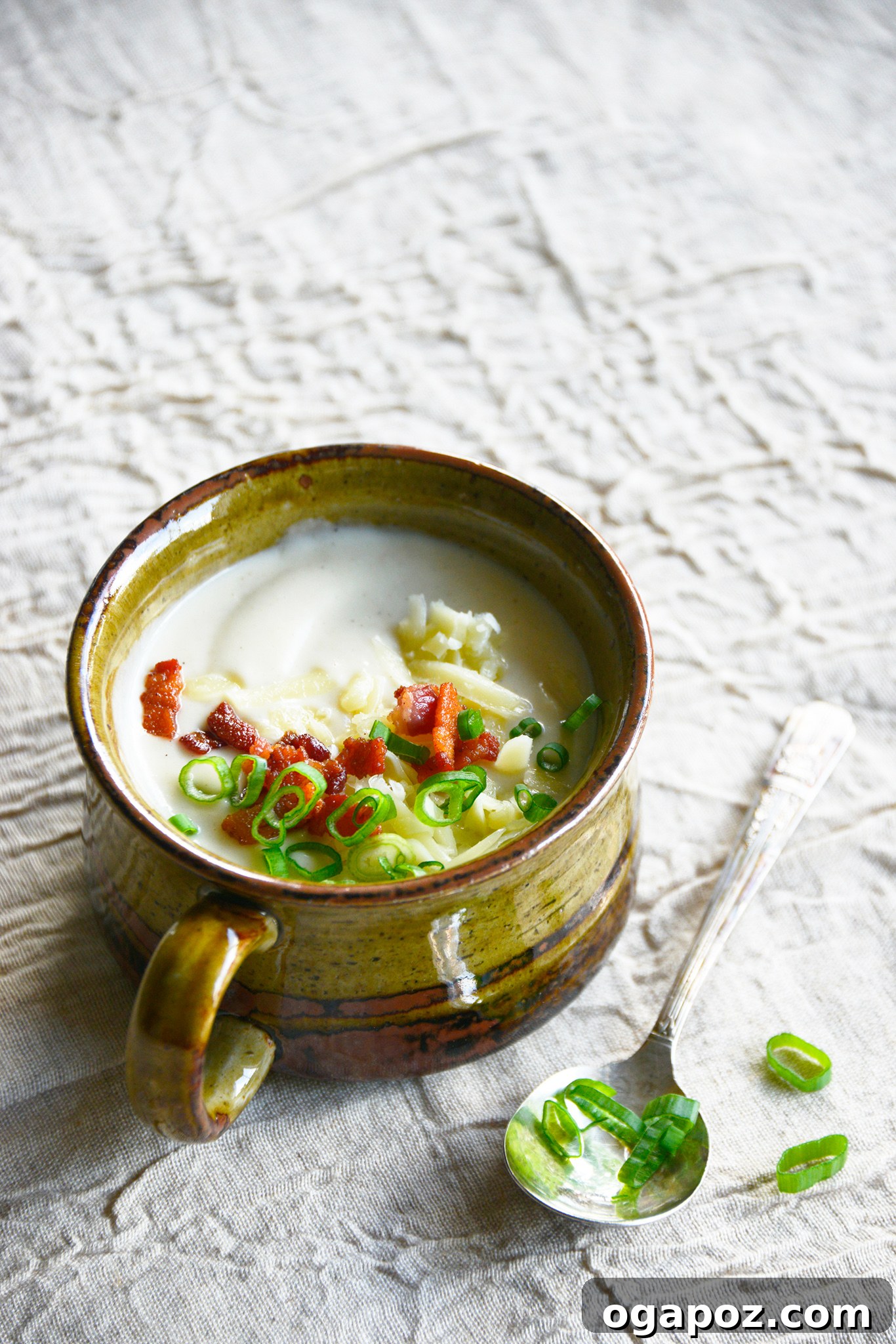 Instant Pot Cauliflower Soup in a bowl with a spoon.