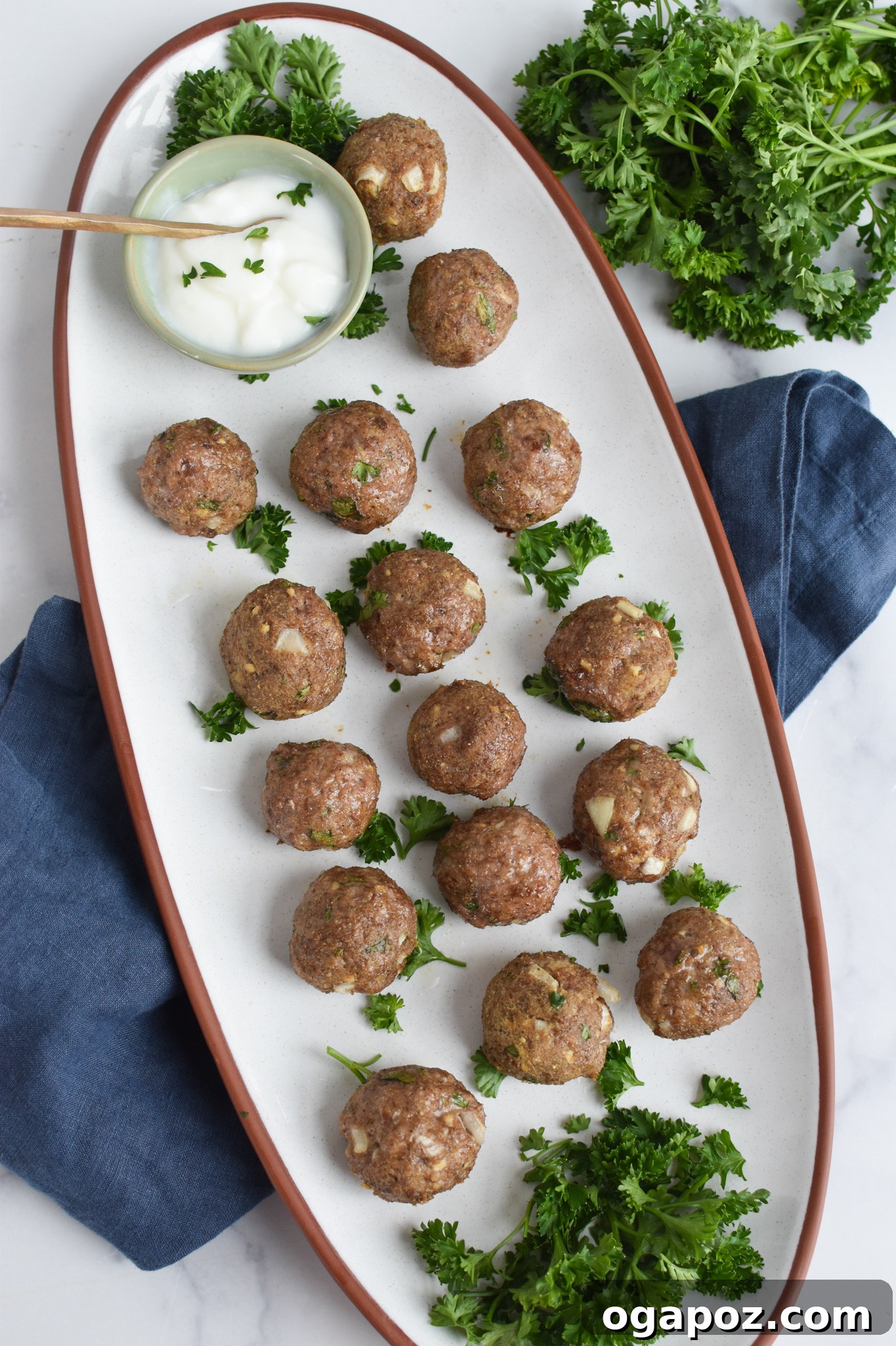 Spiced Lamb Kofta 5 Succulent Lamb Kofta arranged appealingly on a clean white platter, showcasing their golden-brown exterior and inviting texture.