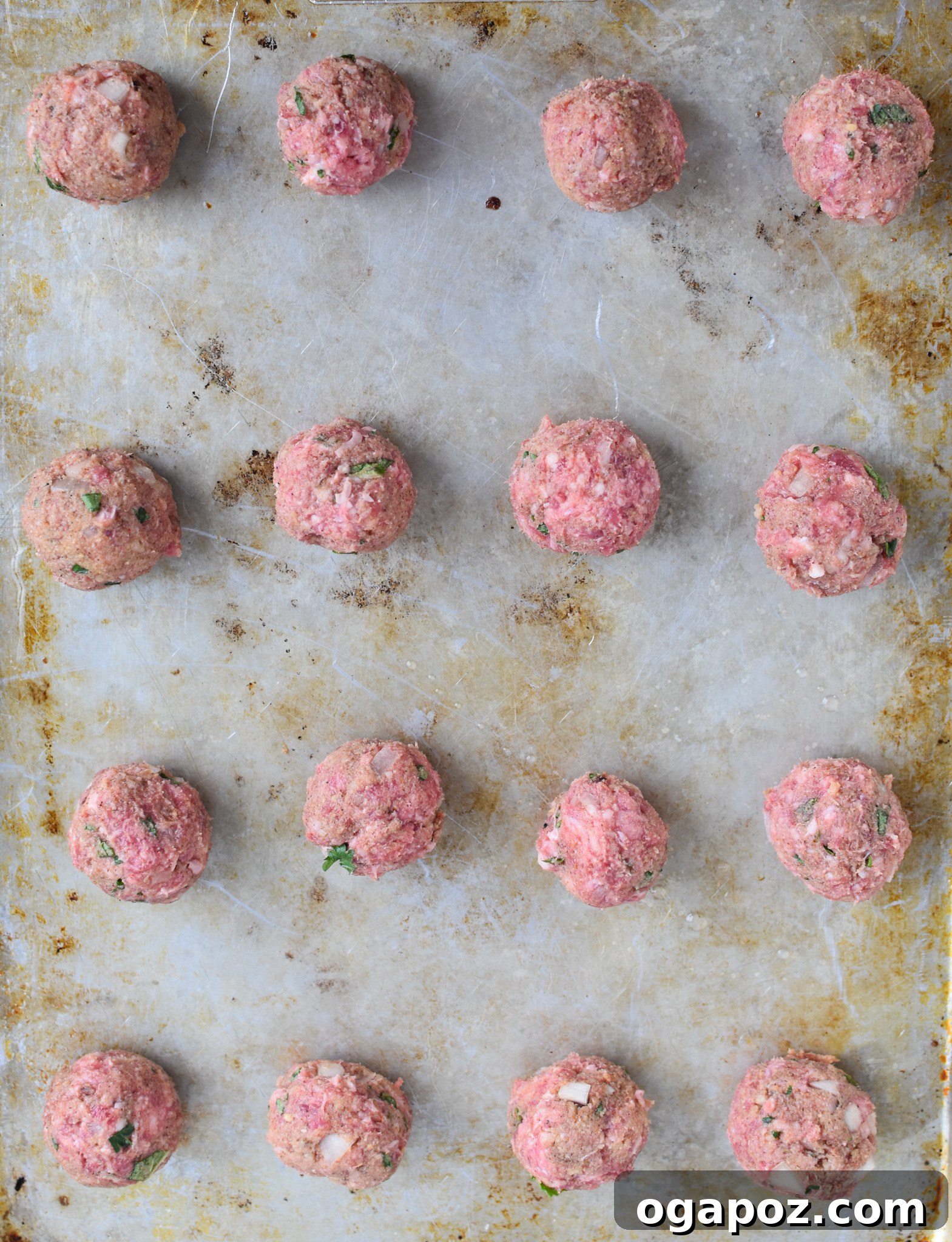 Spiced Lamb Kofta 7 Raw Lamb Kofta meatballs neatly arranged on a baking sheet, ready for the oven or grill.