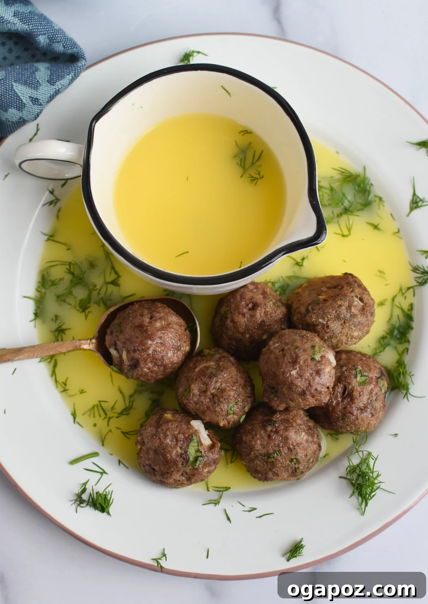 Spiced Lamb Kofta 10 Lamb Kofta drizzled with a bright lemon sauce, ready to be served and enjoyed.