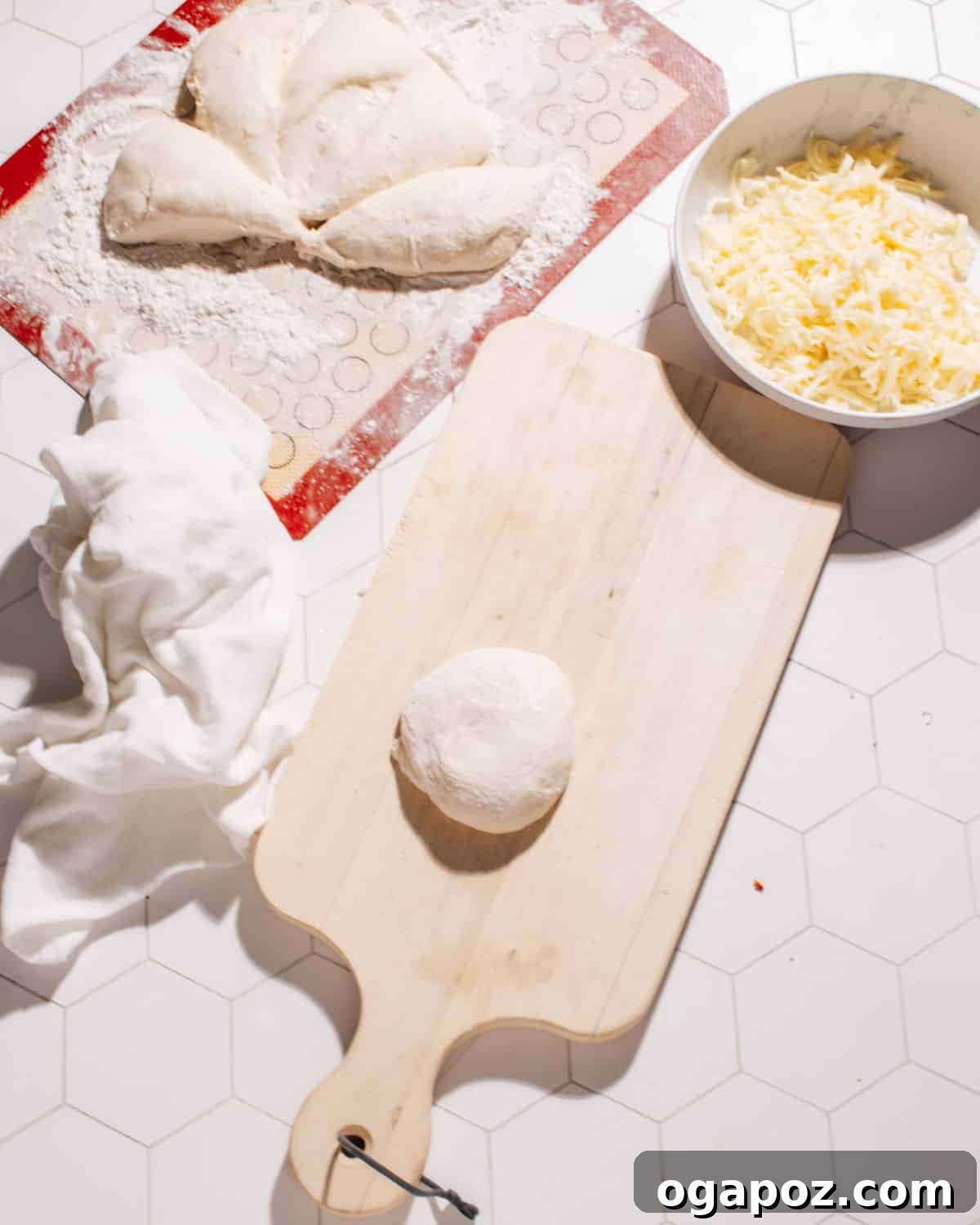 Gooey Cheese Naan 3 Soft naan dough being kneaded on a rolling pad, ready for shaping and stuffing.