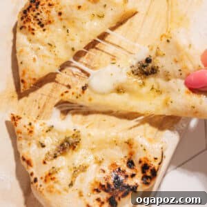 Cheese Naan being pulled apart.