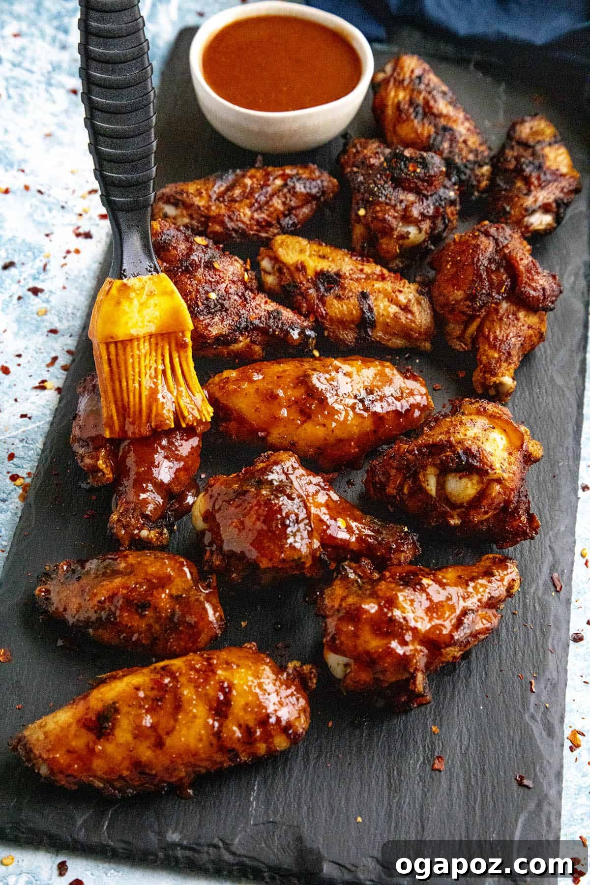 10 Grilling Secrets for Perfect Crispy Chicken Wings 3 Vibrantly colored Honey Sriracha Chicken Wings on a plate.