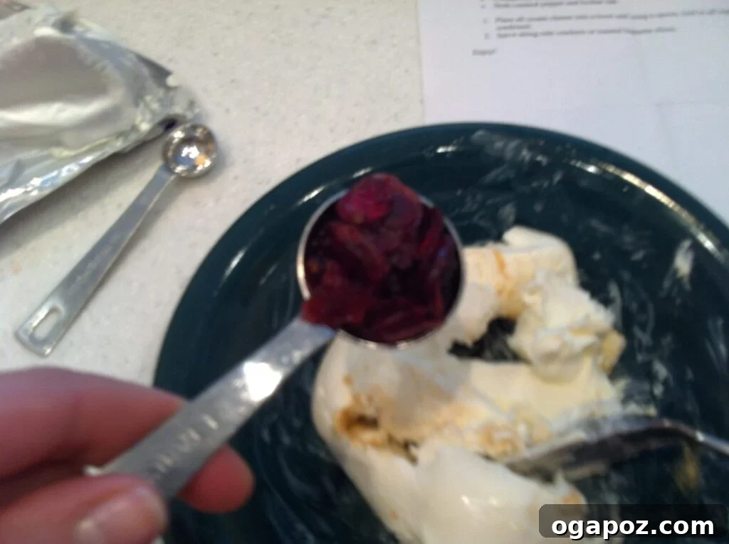 Cranberries and rosemary added Mixing dried cranberries into cream cheese for the spread