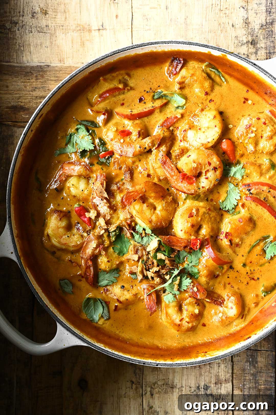 Healthy Shrimp Dinners You'll Crave 21 Creamy Shrimp and Chickpea Curry, garnished with fresh herbs.