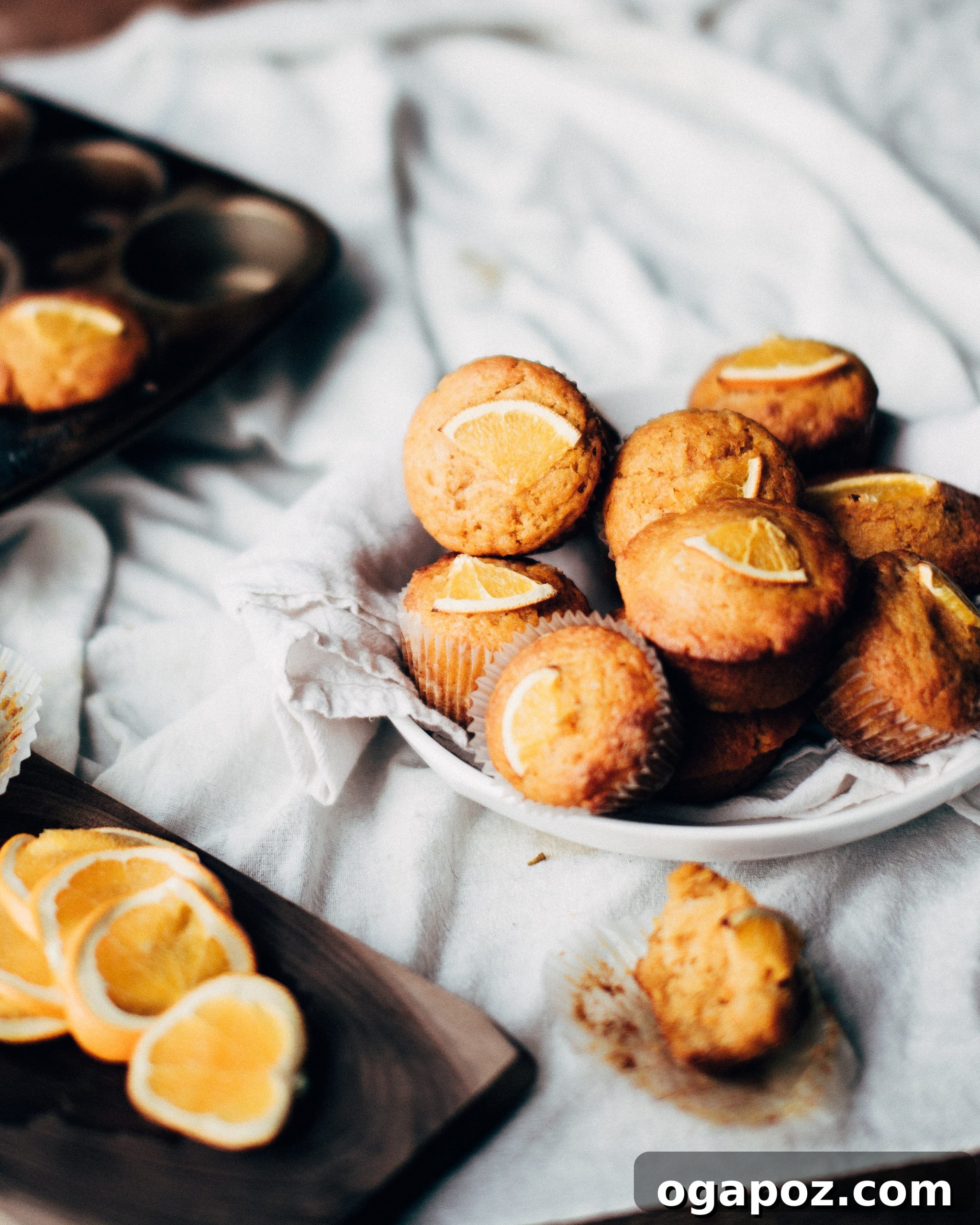 Zesty Orange Pumpkin Muffins 6 A freshly baked Pumpkin-Orange Muffin placed on a wooden surface, ready to be enjoyed.