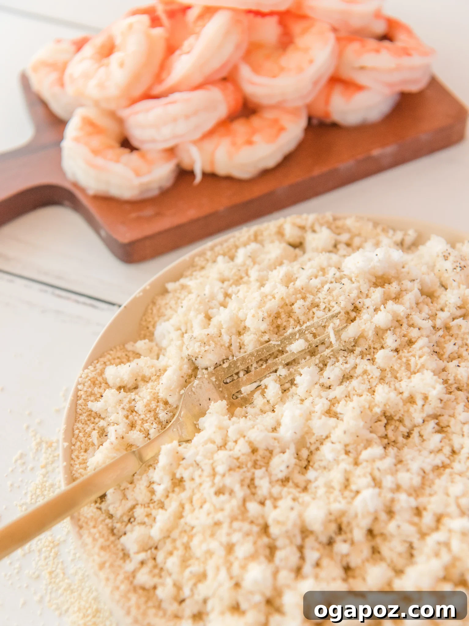 Crispy Air-Fried Coconut Shrimp 5 Air Fryer Coconut Shrimp with fork in a bowl.