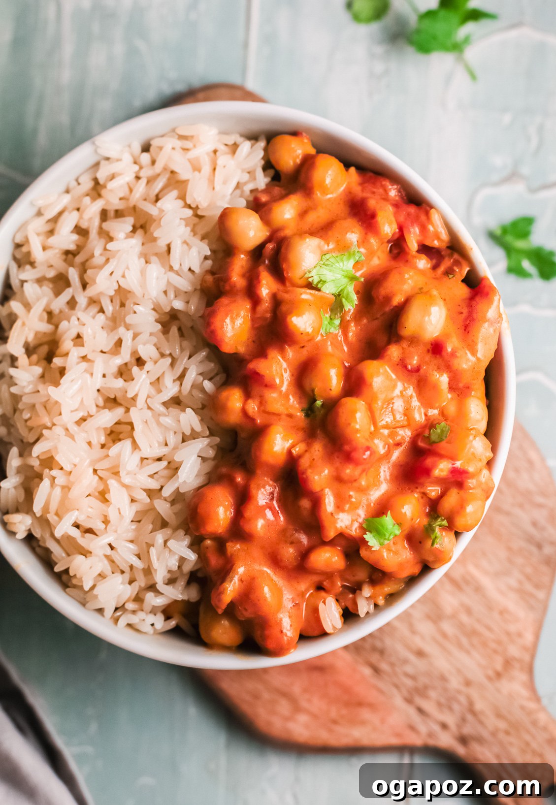 Golden Chickpea Curry 4 A serving of creamy Chickpeas with Curry in a bowl, garnished with fresh parsley.