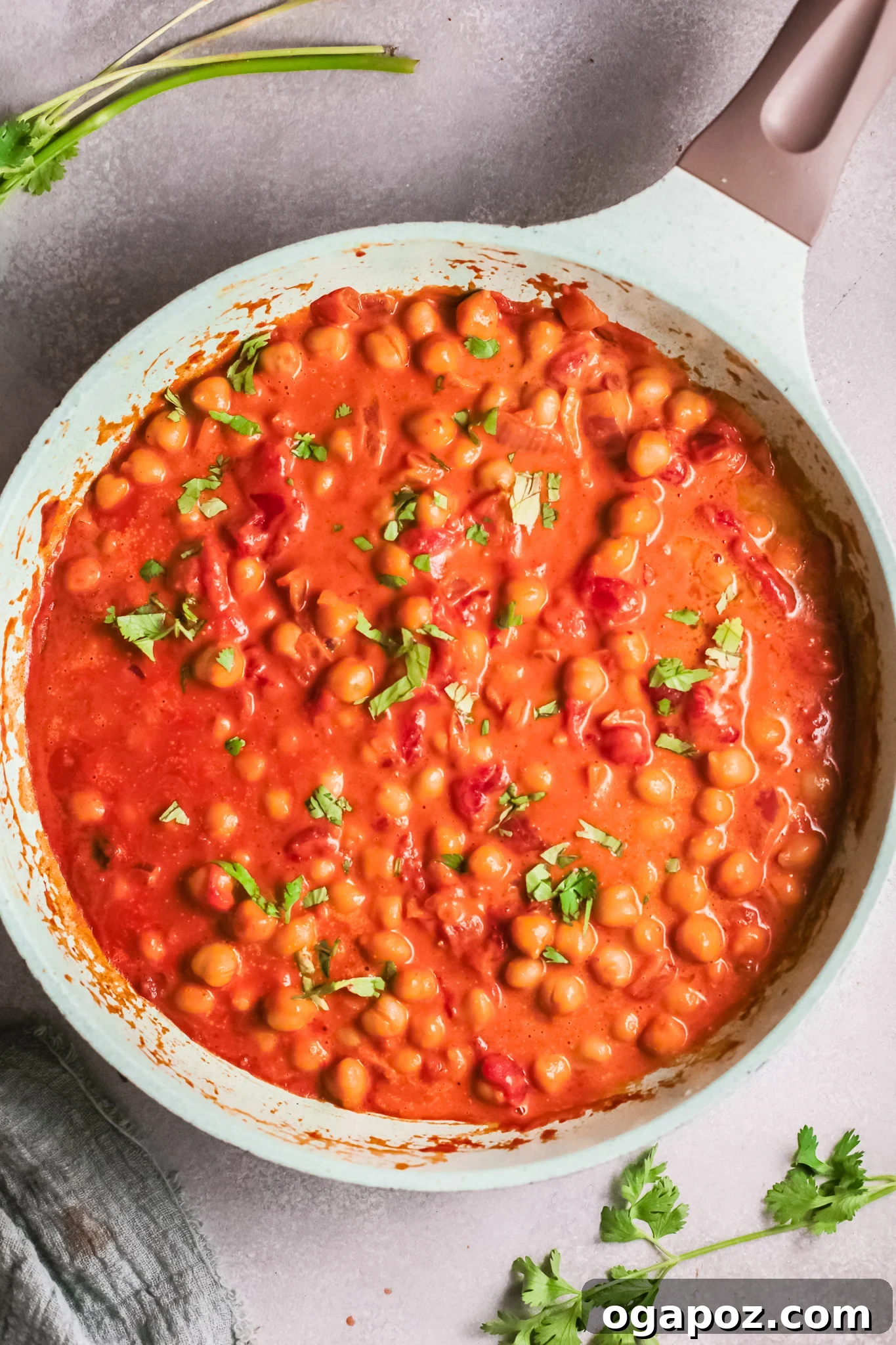 Golden Chickpea Curry 10 Finished Chickpeas with Curry in a skillet, garnished with fresh herbs, ready to be served.