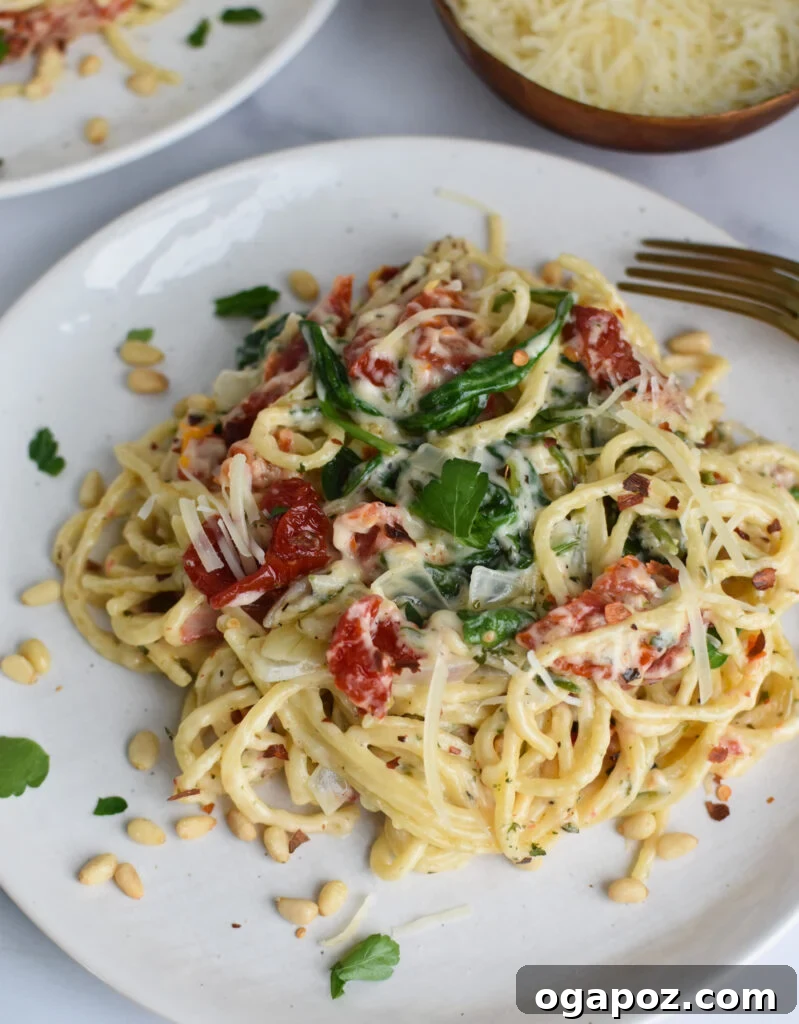 Luscious Creamy Sundried Tomato Pasta 4 Creamy Sun Dried Tomato Pasta Recipe served on a white plate, garnished with fresh herbs.