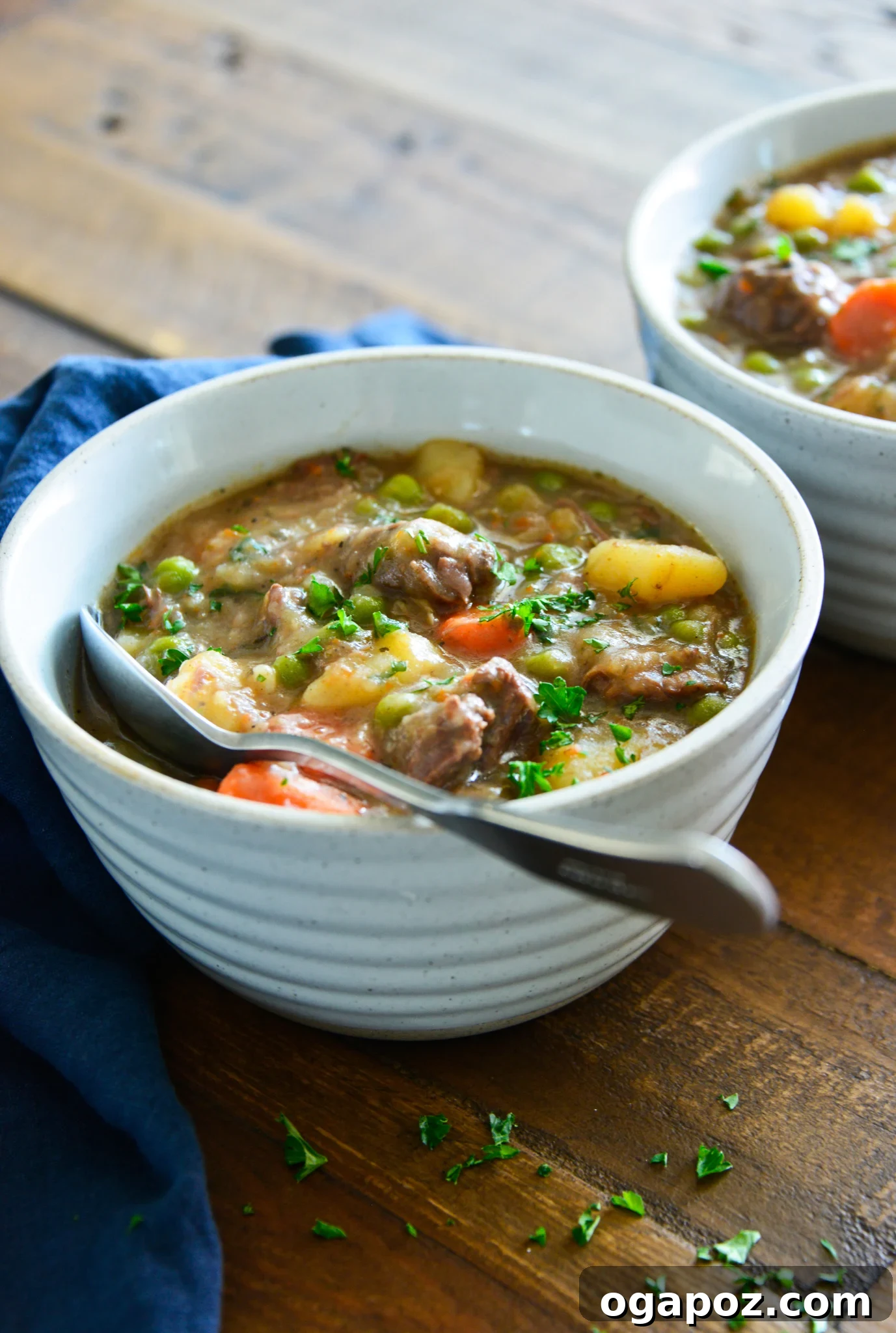 Quick and Tender Instant Pot Beef Stew 4 Instant Pot Beef Stew Recipe, served in a bowl, garnished with fresh herbs