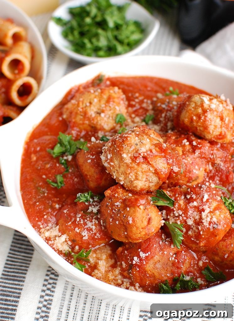 Tender Slow Cooker Turkey Meatballs 3 Close-up of Crockpot Turkey Meatballs in a white bowl, garnished with fresh parsley