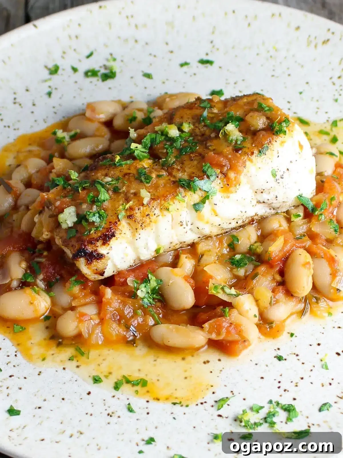 Halibut Perfection: Recipes You'll Adore 21 Pan-fried halibut served with creamy white beans and a fresh gremolata, offering rich flavors with a bright finish.