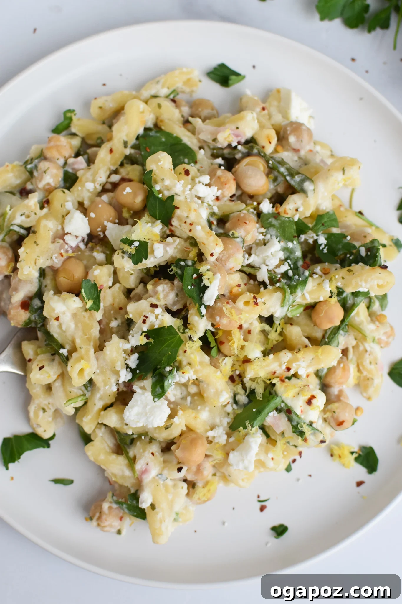 Mediterranean Chickpea Feta Pasta 2 Chickpea Pasta Recipe with Feta on a white plate, garnished with fresh herbs.