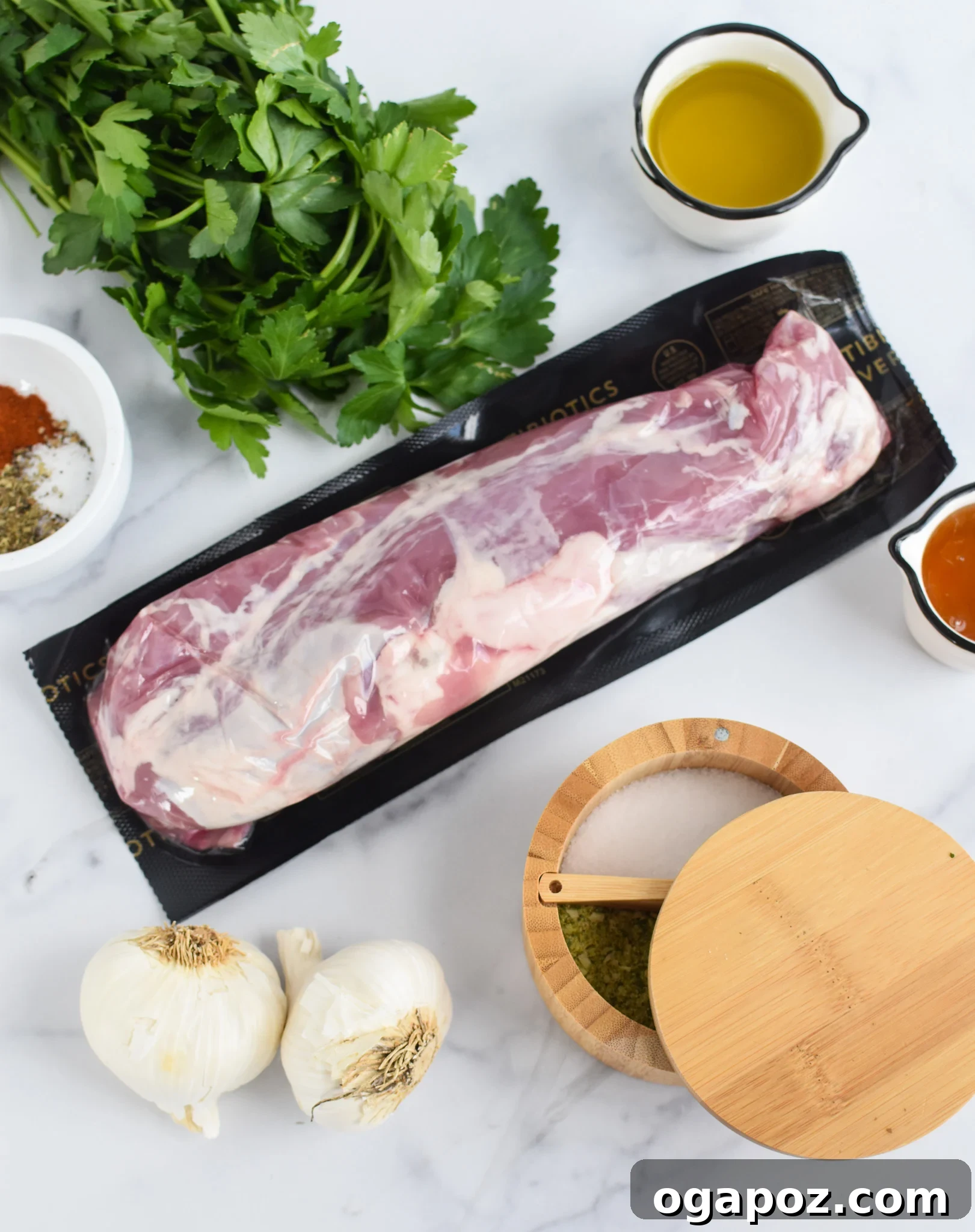 Perfectly Seared Cast Iron Pork Tenderloin 3 A collection of fresh ingredients laid out, including pork cubes, spices, honey, and fresh vegetables for the orzo salad.
