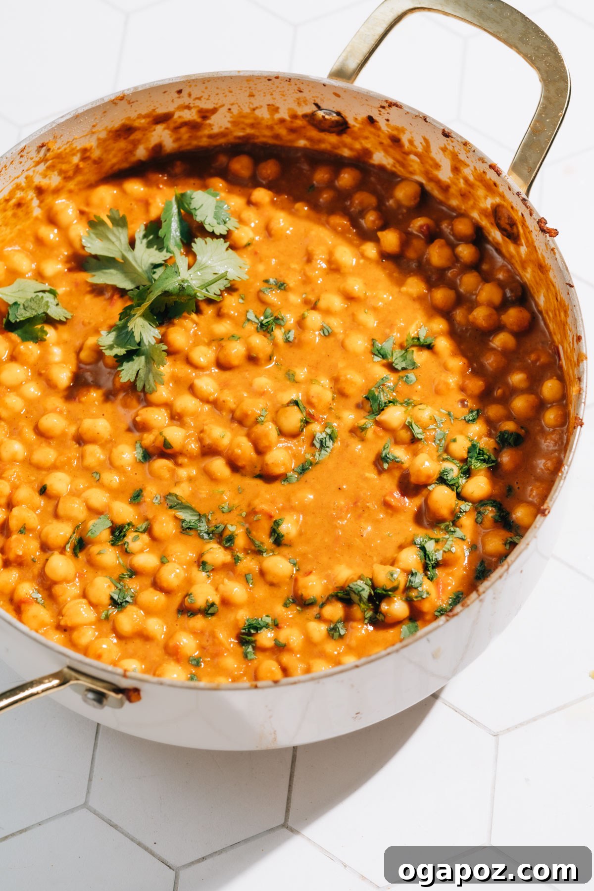 Speedy Coconut Curry Chickpeas 7 A large pot brimming with aromatic Curry Chickpeas, garnished with vibrant green cilantro