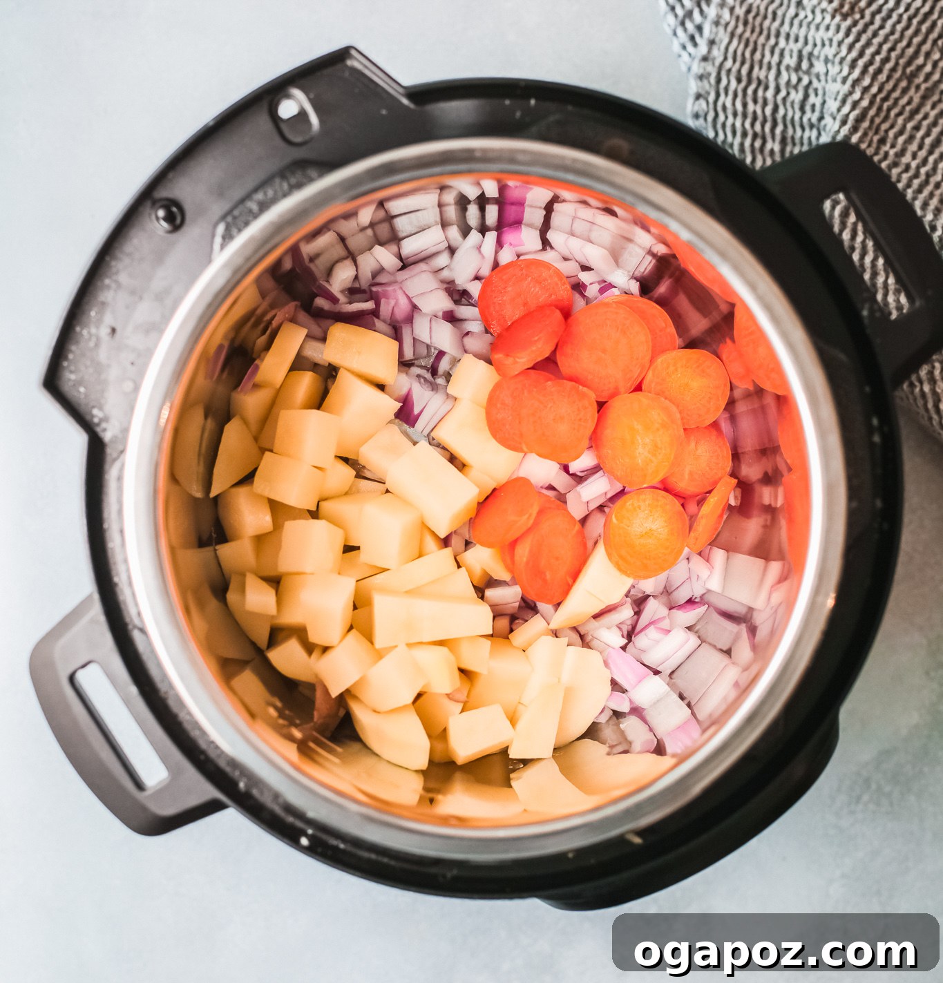 All the initial ingredients for Instant Pot Bean Soup, including chopped vegetables, broth, and oil, assembled in the Instant Pot before cooking.