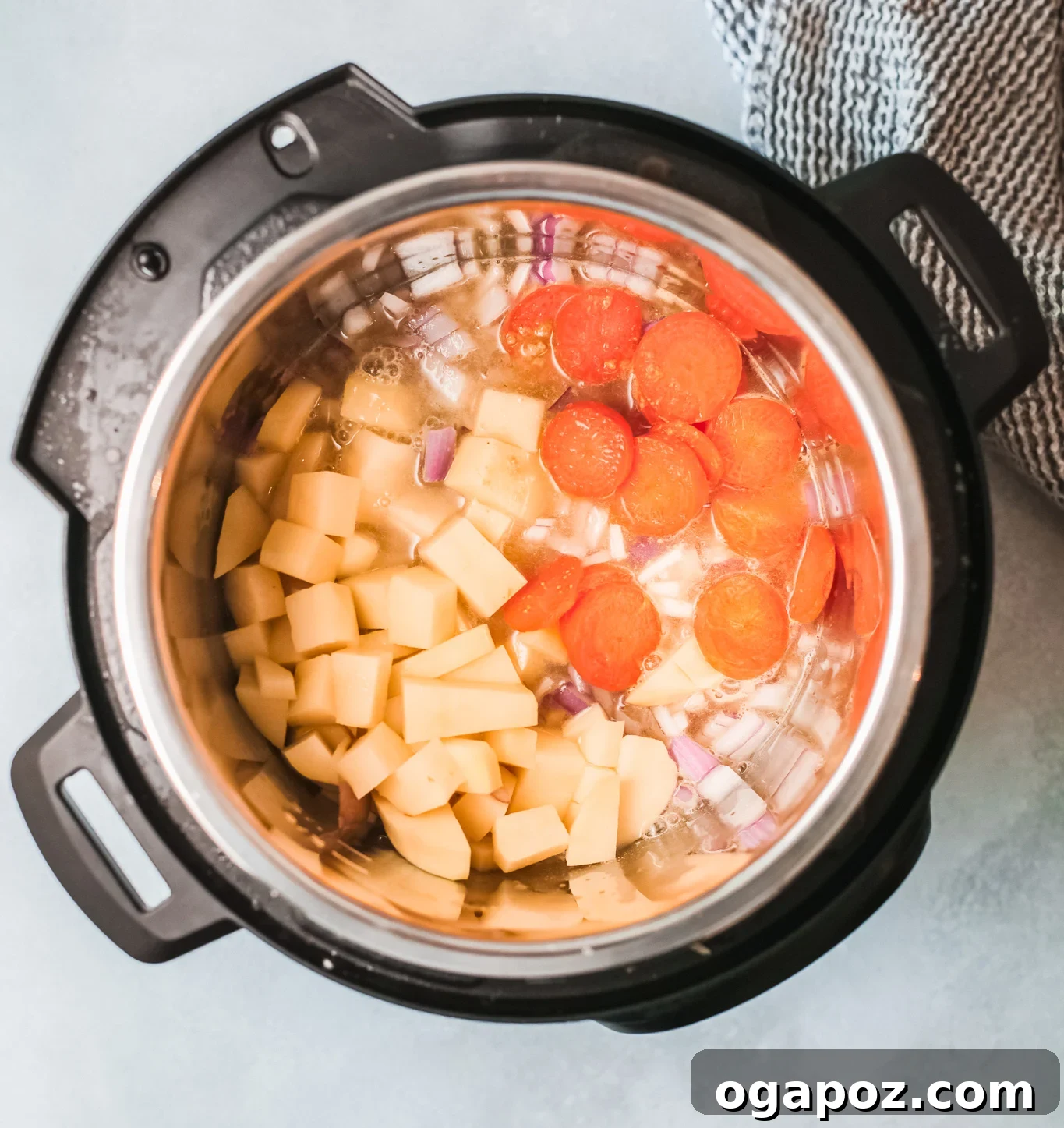 Instant Pot showing the sautéed carrots and red onion, forming the foundational flavor base for the bean soup.