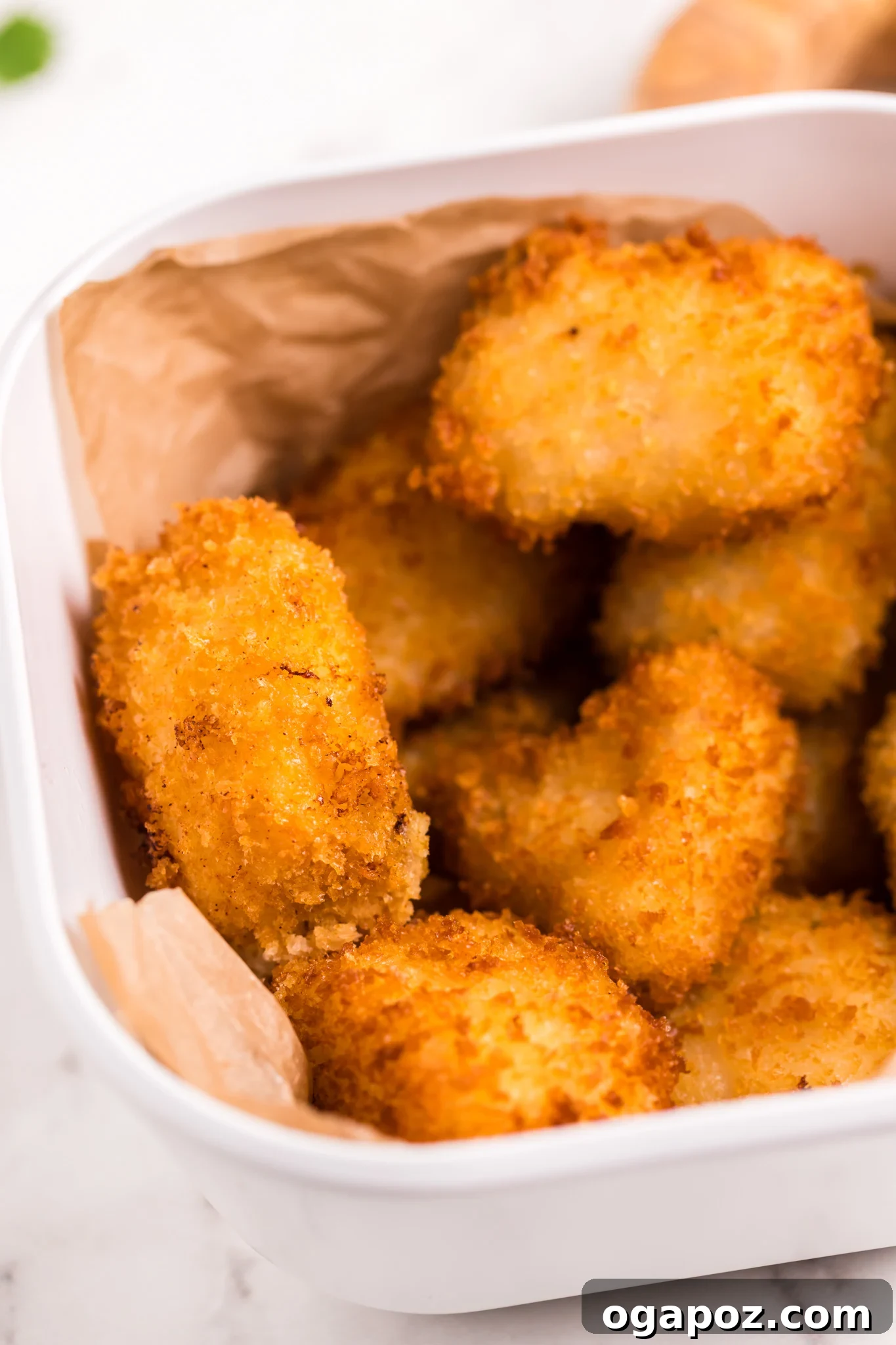 Crispy Air Fryer Tilapia 2 Crispy Air Fryer Tilapia in a basket, freshly cooked and golden brown.