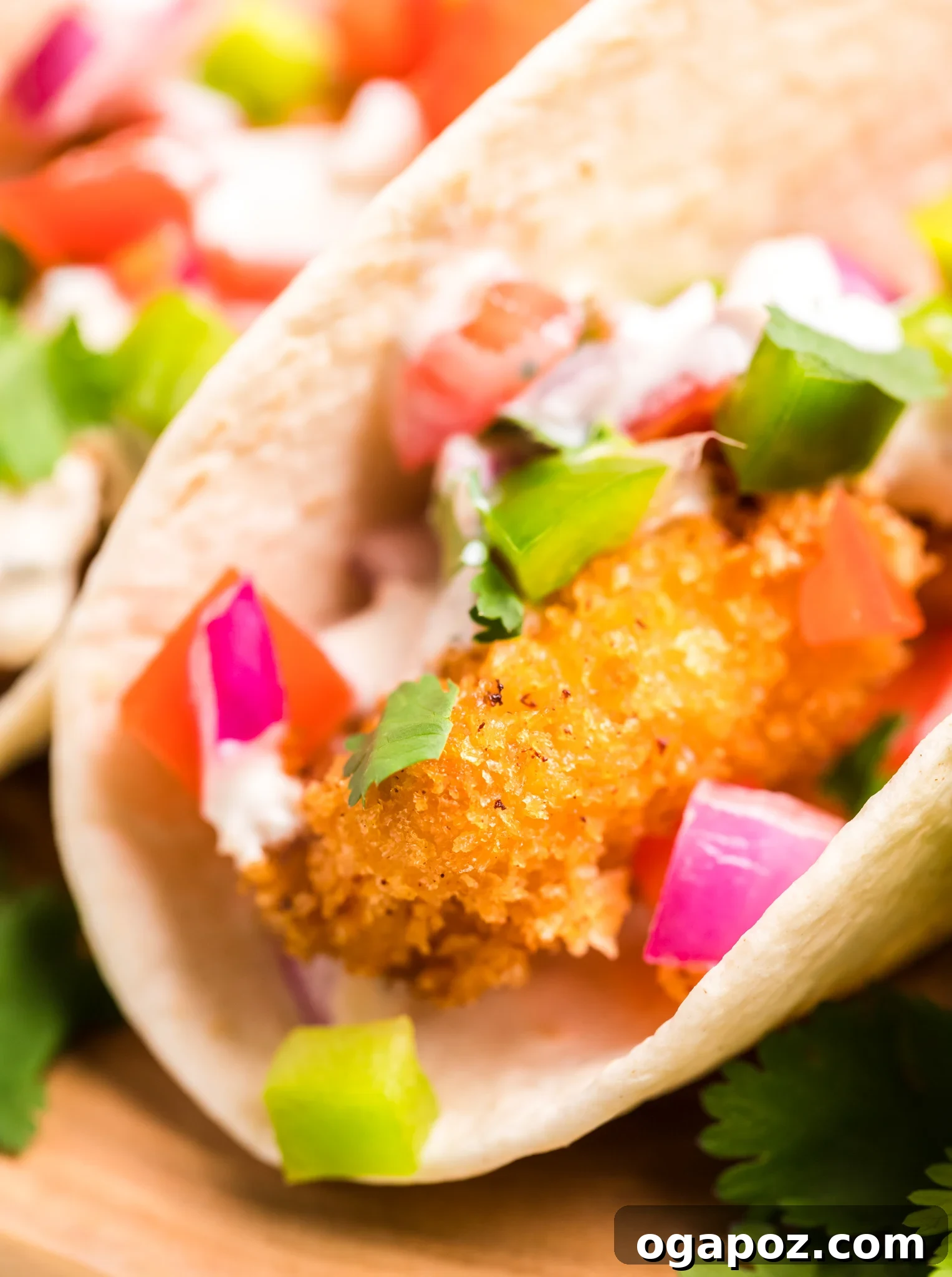 Zesty Tilapia Tacos 6 Tilapia Fish Tacos garnished with diced tomatoes and fresh cilantro.