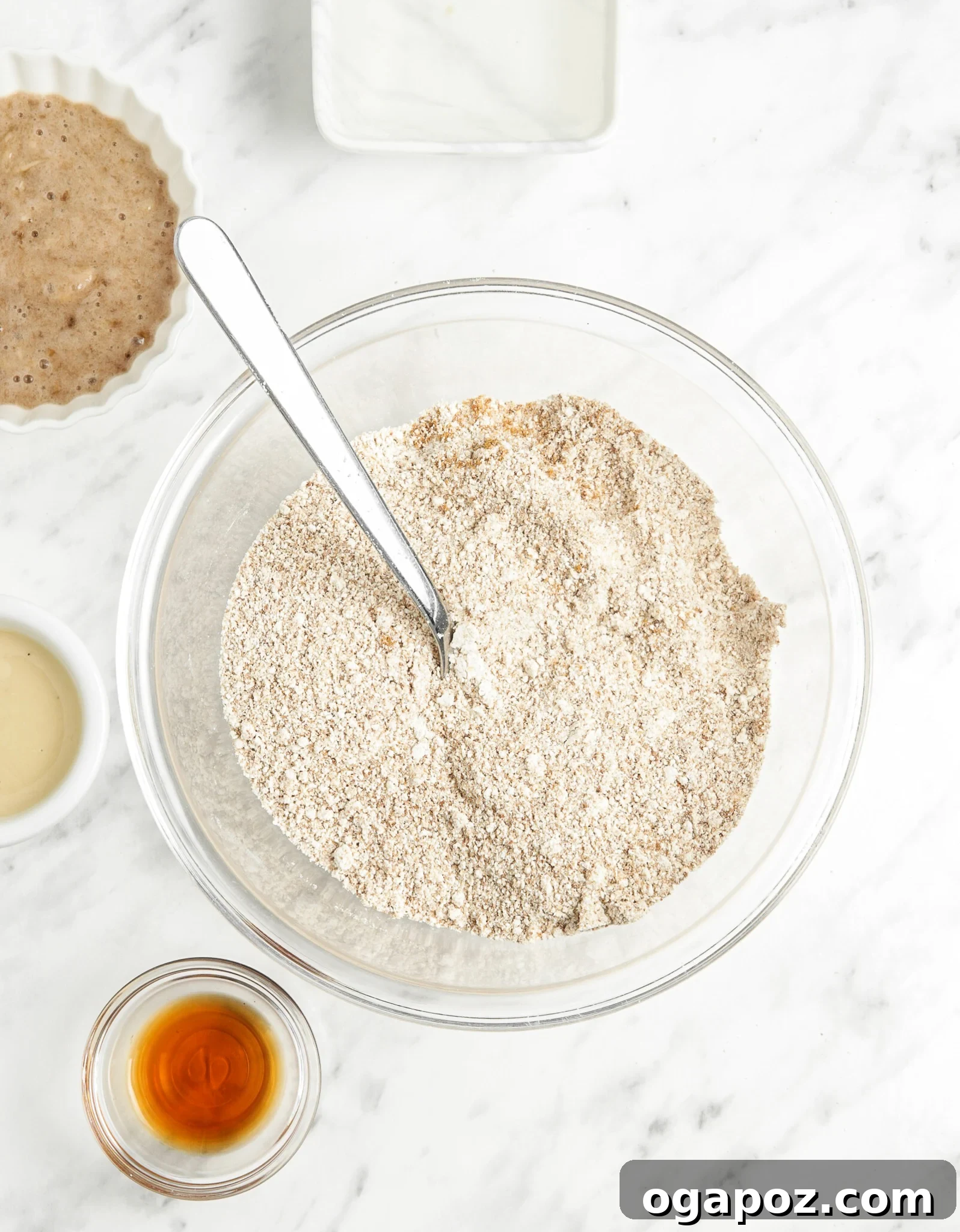 Soft-Baked Banana Oatmeal Cookies 5 Dry ingredients for Homemade Banana Oatmeal Cookies, including oat flour, coconut sugar, and baking powder, mixed in a bowl.