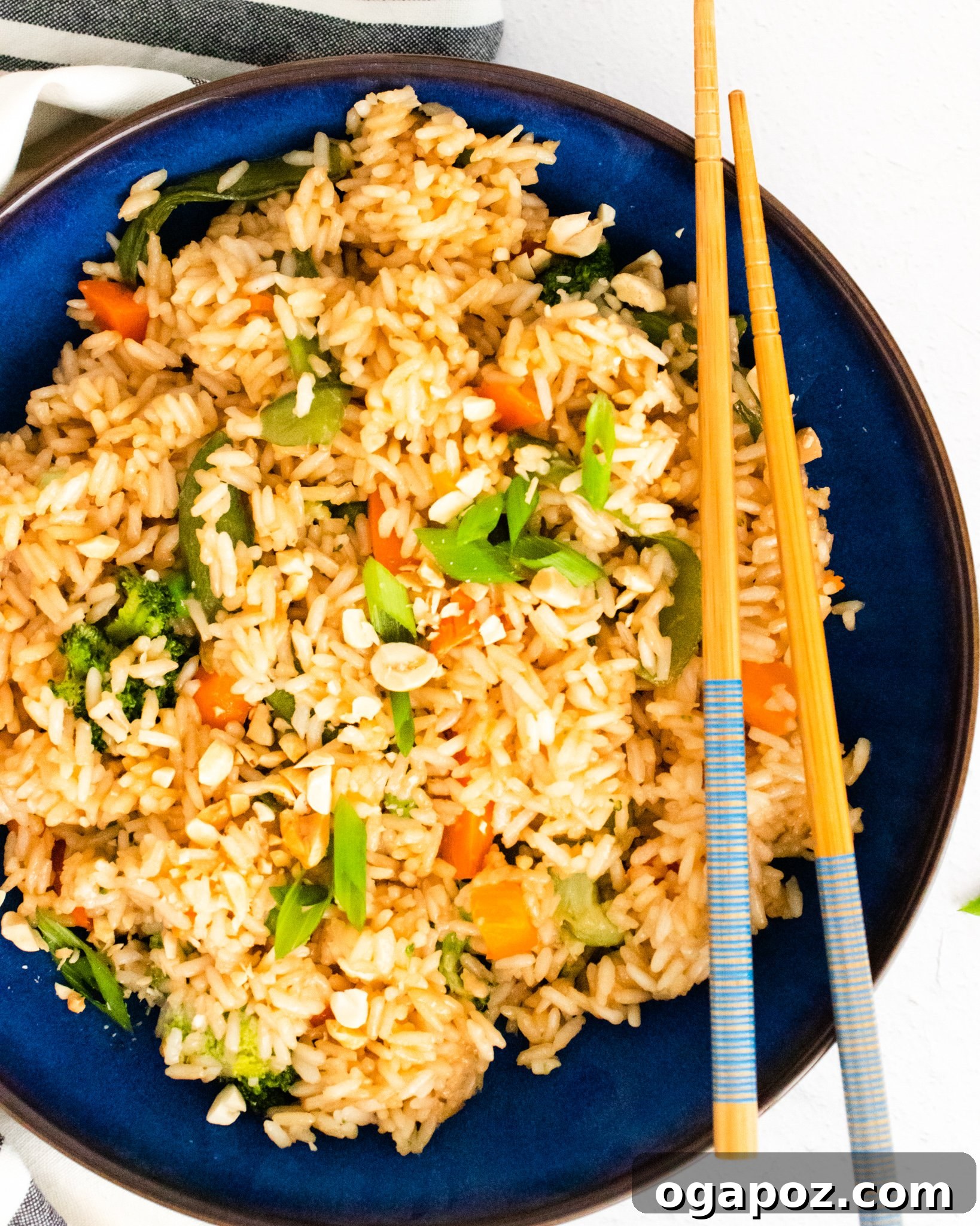 Effortless Instant Pot Fried Rice 2 A serving of Instant Pot Fried Rice in a blue bowl, garnished with green onions.