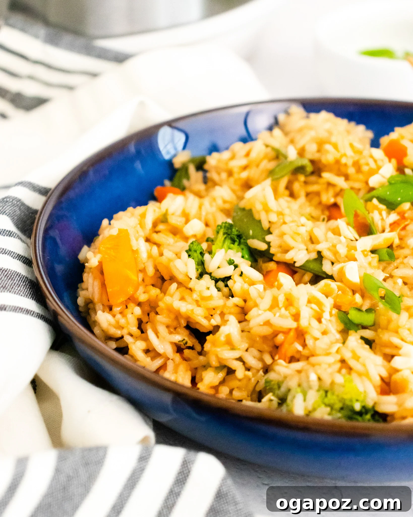 Effortless Instant Pot Fried Rice 4 Instant Pot Fried Rice in a blue bowl with chopsticks.