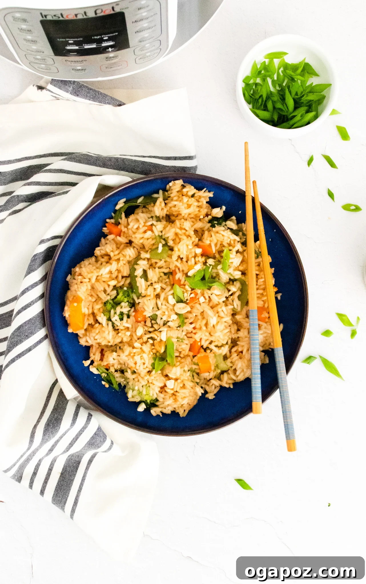 Effortless Instant Pot Fried Rice 6 Instant Pot Fried Rice in a blue bowl with chopsticks, ready to eat.